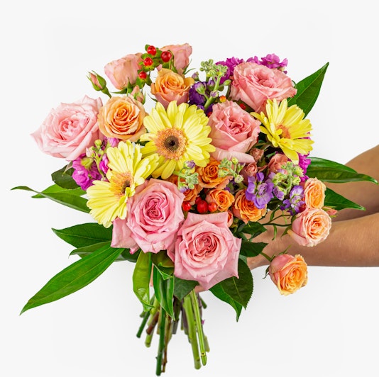 Vibrant floral bouquet featuring pink roses, sunny gerberas, and colorful accents.