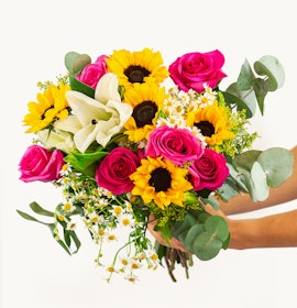 Vibrant bouquet featuring pink roses, sunflowers, and white blooms, ideal for cheerful occasions.