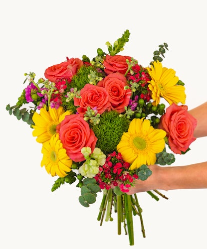 Vibrant bouquet of orange roses, yellow daisies, and lush greenery for cheerful occasions.