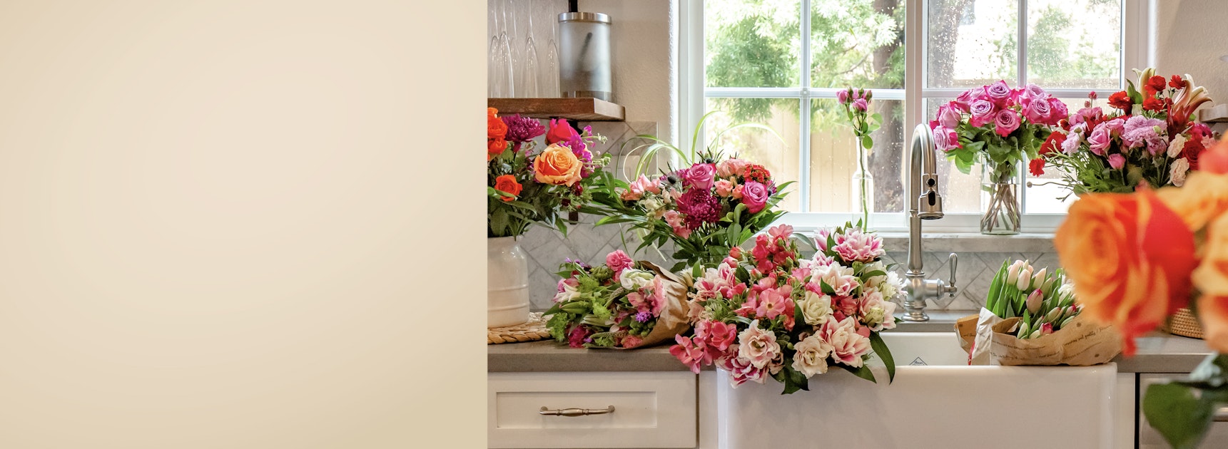 A vibrant floral display featuring assorted roses and mixed blooms in a charming kitchen setting.
