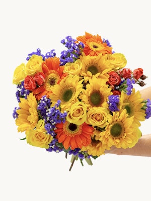 Vibrant bouquet featuring sunflowers, roses, and seasonal blooms in a cheerful arrangement.